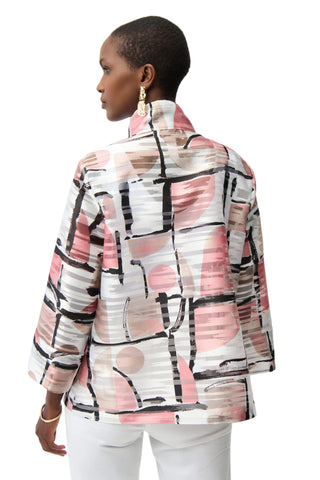Woman wearing a patterned jacket with abstract designs on a white background