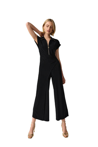 Woman wearing a black jumpsuit on a white background