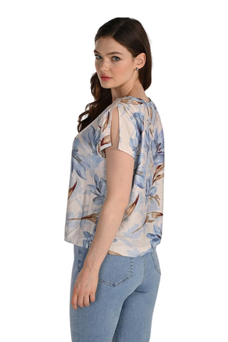 Woman wearing a floral blouse and jeans on a white background