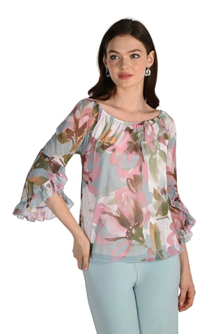 Woman wearing a floral blouse with ruffled sleeves on a white background
