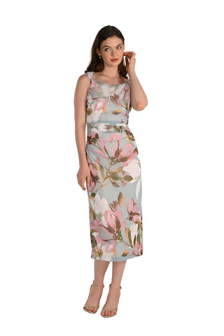 Woman wearing a floral dress on a plain background