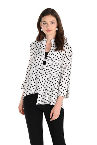 Woman wearing a black and white polka dot blouse on a white background