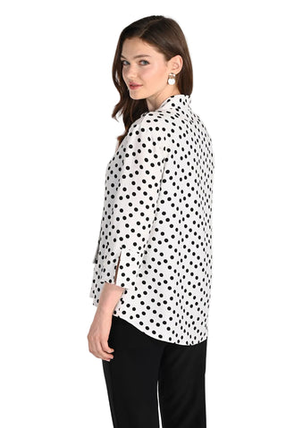 Woman wearing a polka dot blouse on a white background