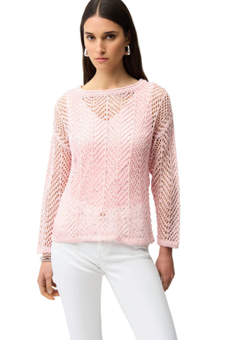 Woman wearing a pink knitted sweater on a white background
