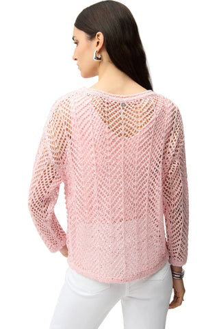 Woman wearing a pink knitted sweater on a white background