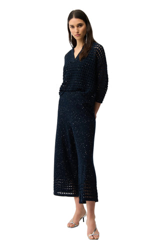 Woman wearing a dark blue dress with a white background