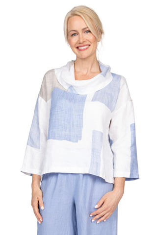Woman wearing a light blue and white patterned top with matching pants on a plain background