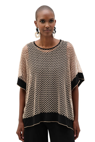 Woman wearing a patterned top with black accents on a white background