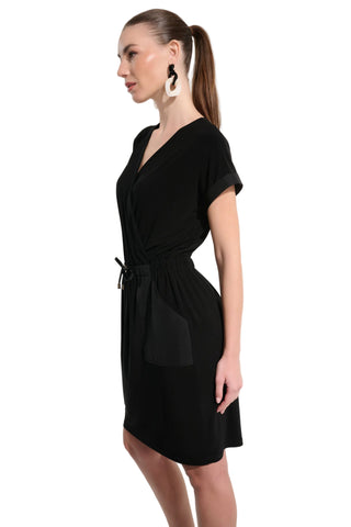 Woman wearing a black dress against a white background