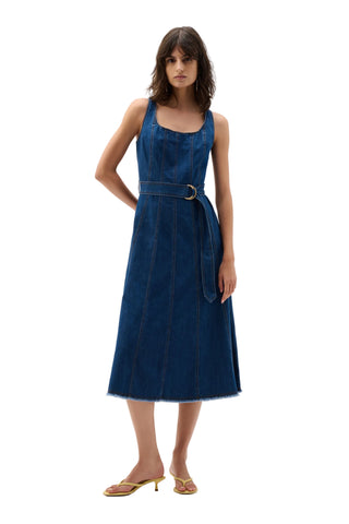 Woman wearing a blue denim dress on a white background