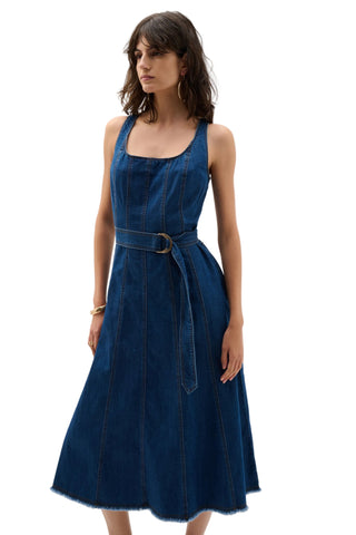 Woman wearing a blue denim dress on a white background