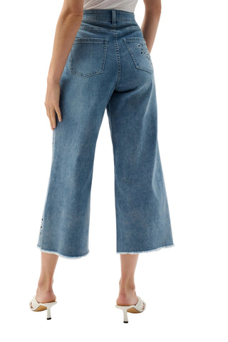 Blue denim wide-leg pants worn by a person on a white background