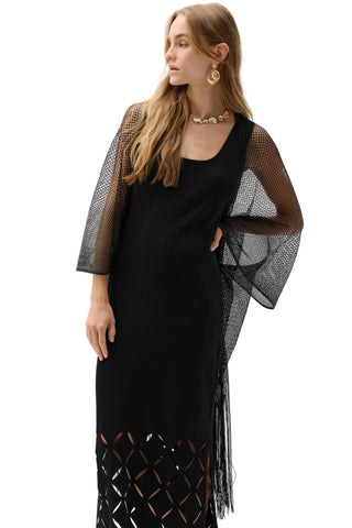 Woman wearing a black dress with a sheer mesh cover-up on a white background