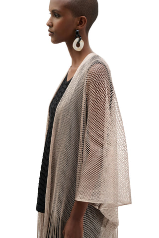 Woman wearing a beige knitted cardigan on a white background