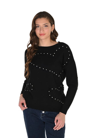 Woman wearing a black sweater with pearl embellishments on a white background