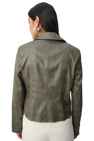Green leather jacket worn by a person on a white background