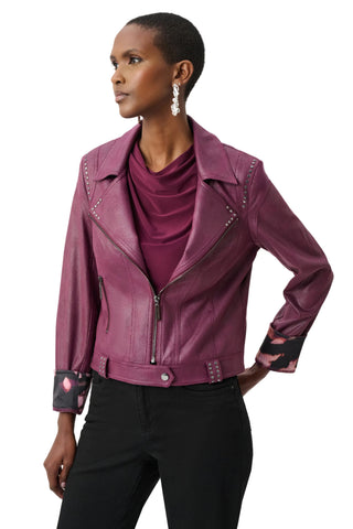 Woman wearing a purple leather jacket on a white background