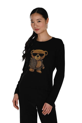 Woman wearing a black sweater with a teddy bear design on a white background
