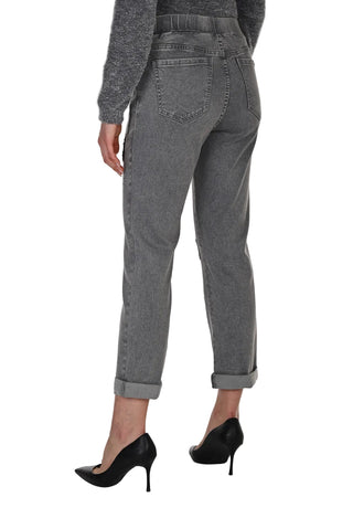 Person wearing gray pants and black high heels on a white background