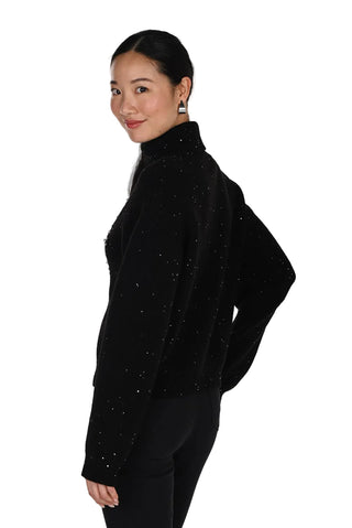 Woman wearing a black turtleneck sweater on a white background