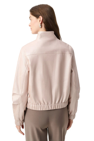 Woman wearing a beige jacket on a light gray background