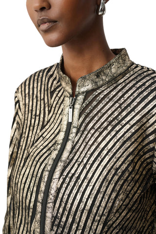 Close-up of a person wearing a patterned jacket with a neutral background