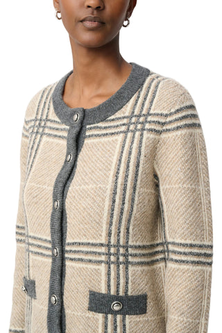 A close-up of a model wearing a beige and gray plaid knit cardigan with a gray button placket and gray ribbed collar.