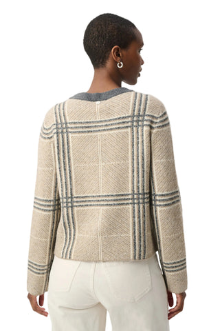A woman shown from the back wearing a cropped knit sweater with a beige base and gray windowpane plaid pattern, paired with white pants, against a light gray studio background.