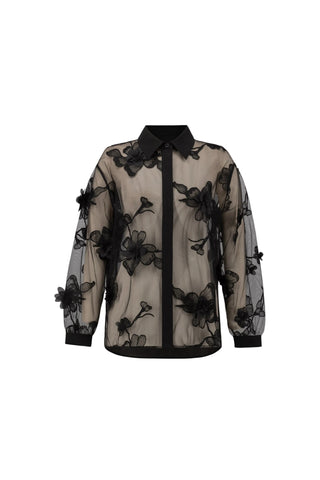 Sheer blouse with black floral embroidery on a white background