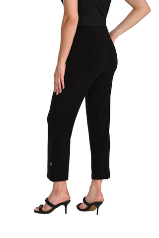 Person wearing black high-waisted pants on a white background