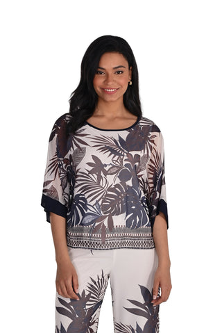 Woman wearing a patterned top and pants on a white background