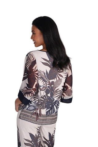 Woman wearing a patterned dress with a white background