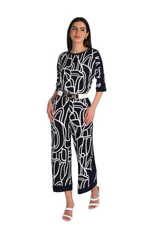 Woman wearing a black and white patterned outfit on a white background