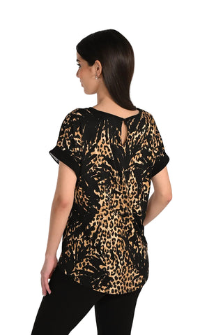 Woman wearing a leopard print top on a plain background