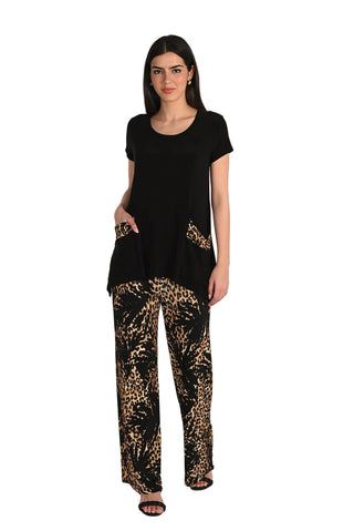 Woman wearing a black top and leopard print pants on a white background