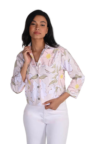Woman wearing a floral patterned shirt against a white background