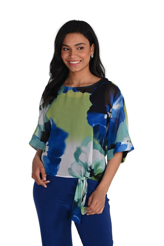 Woman wearing a colorful blouse with abstract patterns on a white background