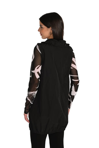 Black hoodie with sheer sleeves and white patterns worn by a model on a white background