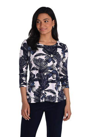 Woman wearing a black and white floral patterned top on a white background