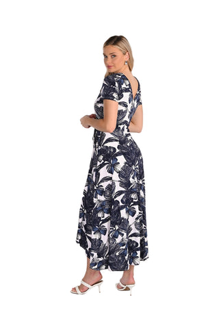 Woman wearing a navy floral dress on a white background