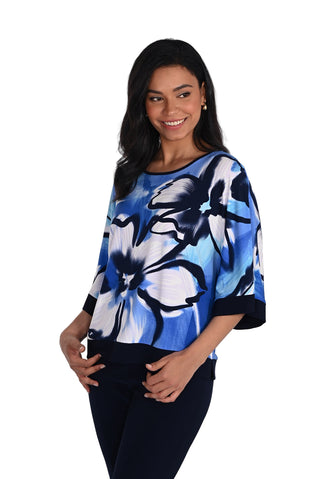 Woman wearing a blue floral patterned top on a white background