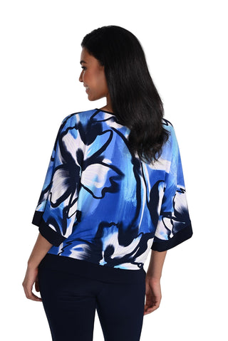 Woman wearing a blue floral blouse against a white background