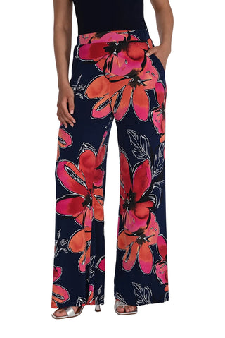 Navy pants with red floral pattern worn by a person on a white background