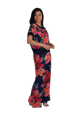 Woman wearing a navy blue outfit with red floral patterns on a white background