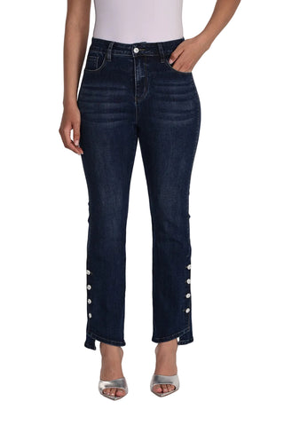 Dark blue jeans with button details worn by a person on a white background