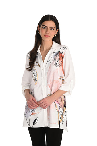 Woman wearing a white blouse with floral patterns on a plain background