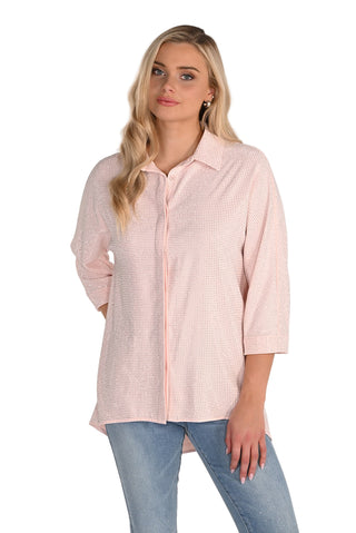 Woman wearing a light pink checkered shirt and blue jeans on a white background