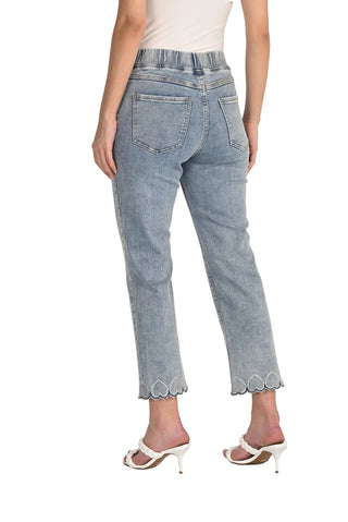 Light blue jeans with scalloped hem worn by a person on a white background