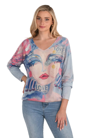 Woman wearing a colorful long-sleeve top with a face design and 'LOVE' text on a white background