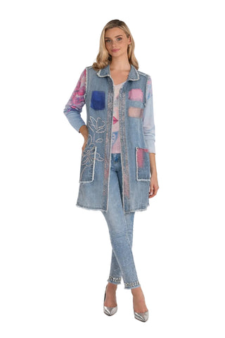 Woman wearing a colorful denim jacket with a white background